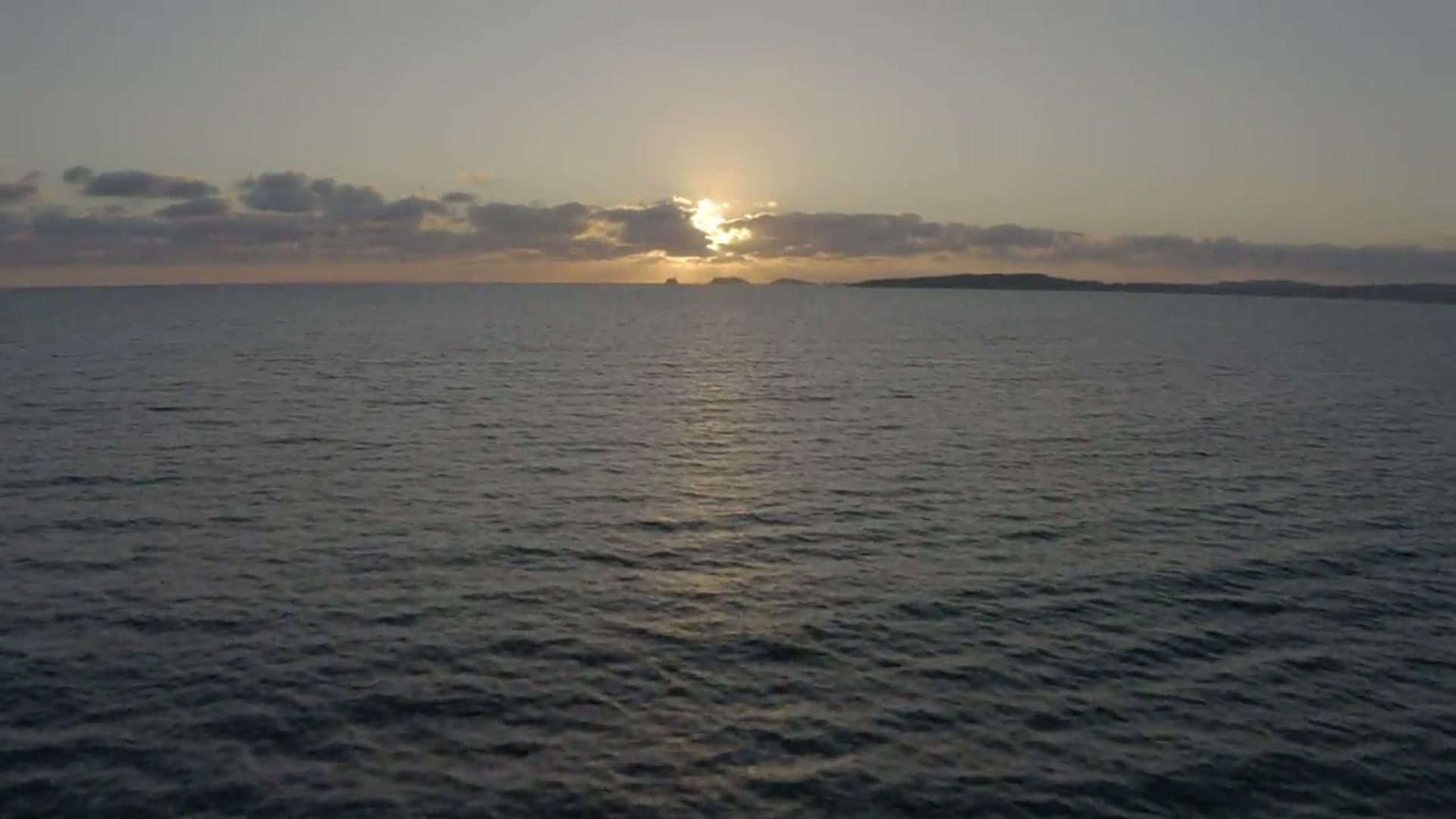 Aerial view of ocean at sunset