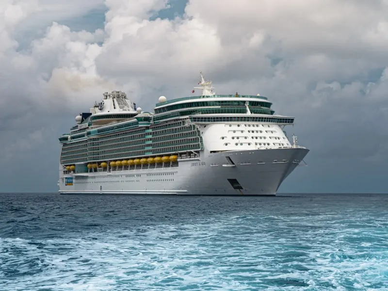 Royal Caribbean cruise ship at sea with crown-and-anchor marking